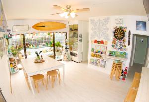 a dining room with a table and chairs at Splash Guest House in Katsuura