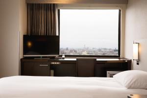 Postel nebo postele na pokoji v ubytování Kawasaki Nikko Hotel