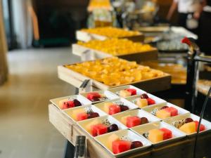 a row of trays filled with fruits and vegetables at Banyan Tree Yangshuo in Yangshuo