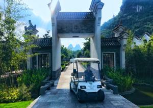 a golf cart parked in front of a building at Banyan Tree Yangshuo in Yangshuo