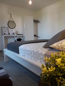 a bedroom with a bed with a table and a mirror at ZARA APARTMENT in Banjole
