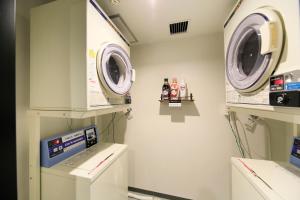 a laboratory with two washing machines in a room at Hotel NewNagano NeXT in Nagano