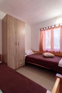 Postel nebo postele na pokoji v ubytování Apartmani Lana + 37 fotografií