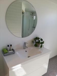 a bathroom with a sink and a mirror at Large apartment with sauna in central Mora in Mora