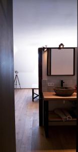 a living room with a table and a mirror at Muntershof in Velzeke-Ruddershove