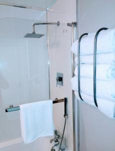 a towel rack in a bathroom with towels at Boutique Coastal appt nr Edinburgh in Saint Davids