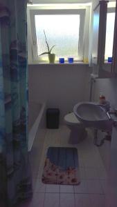 uma casa de banho com um WC e um lavatório. em Ferienwohnung Fusi em Amberg