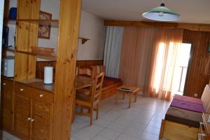 a room with a desk and a table and a chair at Apartamentos Frontera Blanca Nievesol in Pas de la Casa