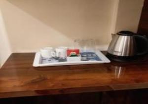 a stove top with cups and a tea pot on a table at Ganga Darshan in Varanasi