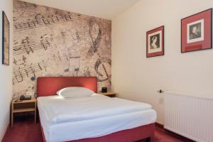 Postel nebo postele na pokoji v ubytování Hotel Aigner