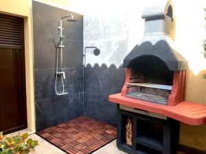 a bathroom with a shower with a pizza oven at Casa Coromines in Alcudia