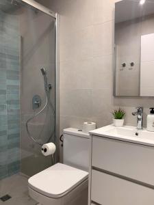 a bathroom with a shower and a toilet and a sink at Casa Coromines in Alcudia +35 photos