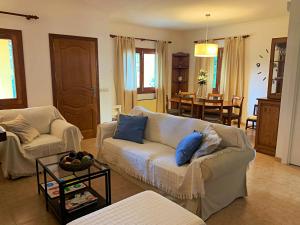 a living room with a couch and a table at Casa Coromines in Alcudia