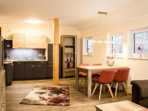 a kitchen and living room with a table and chairs at SALUS Spreewald - Erholung & Natur - in Kolonie