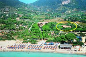 a beach with a bunch of umbrellas and people on it at Residence Golfo Della Lacona in Lacona