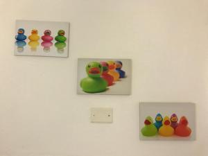 three pictures of rubber ducks on a wall at B&B In Centro in Cagliari