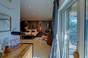 a living room with a couch and a bedroom at Na’ankusê @ Utopia in Windhoek +30 photos