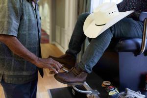 a man in a cowboy hat tying his shoes at Holiday Inn Express Nashville-Downtown Conference Center, an IHG Hotel in Nashville