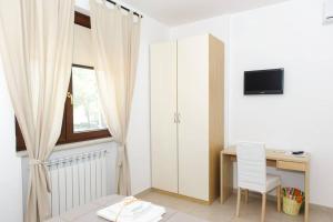 Televízia a/alebo spoločenská miestnosť v ubytovaní Dimora Mariù - Casa Vacanze