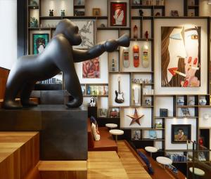 a statue of a man sitting on top of a counter at citizenM New York Bowery in New York