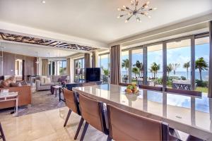 a dining room and living room with a view of the ocean at Royalton Riviera Cancun, An Autograph Collection All-Inclusive Resort & Casino in Puerto Morelos