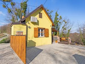 a yellow house with a wooden gate in front of it at Rustic Holiday Home in Donja Stubica with Terrace in Donja Stubica