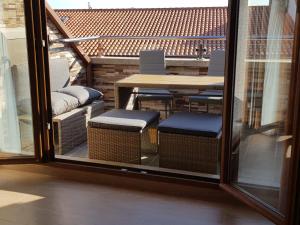 a balcony with a table and chairs outside a window at Apartamentos Playa Compostela in Vilagarcia de Arousa