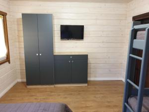 a room with a tv and a cabinet with a television at Дворик Софии in Gribovka