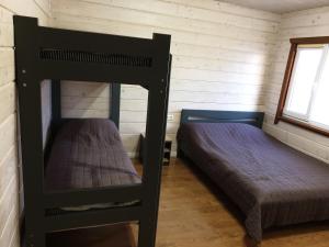 a bedroom with two bunk beds in a cabin at Дворик Софии in Gribovka