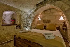 Postel nebo postele na pokoji v ubytování Hidden Cave Hotel
