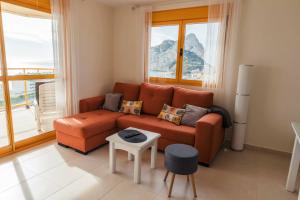 a living room with a couch and a table at En la playa. Planta 19. Vistas espectaculares. 2 terrazas. in Calpe