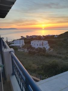 a view of the sunset from the balcony of a house at Απεραντο Γαλαζιο in Agia Pelagia Kythira