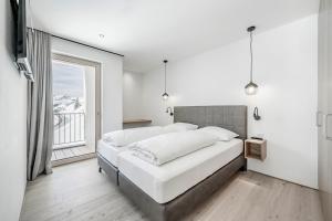 Кровать или кровати в номере Alpenstern Panoramalodge