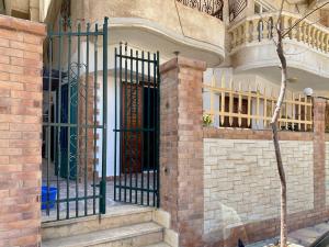 a building with a wrought iron gate in front of a building at Seaside Two-Bedroom Chalet Sidi Krir in Sidi Krir 