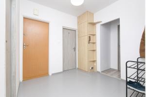 an empty room with a door and a shelf at Rooms4Less in Gdańsk