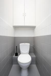 a bathroom with a white toilet and a white cabinet at Rooms4Less in Gdańsk +17 photos