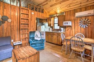 a kitchen and living room with a couch and a table at Rustic Cabin with Hot Tub Near Broken Bow Lake! in Broken Bow