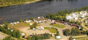 an aerial view of a resort with cars parked on a island in the water at Alta River Camping in Alta