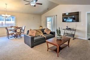 a living room with a couch and a table at Grants Pass Home 1 Mi to Downtown and Rogue River! in Grants Pass