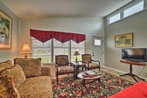 a living room with a couch and chairs and a tv at Coastal Escape with Yard - Walk 1 Mile to Texas AandM! in Corpus Christi