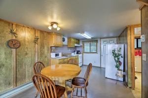 a kitchen with a table and chairs and a refrigerator at Sanderling Sea Cottages, Unit 2 Walk to Coast! in Waldport +19 photos