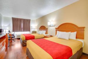 a hotel room with two beds and a desk at Econo Lodge Inn & Suites Albuquerque East I-40 Eubank Exit in Albuquerque