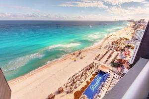 an aerial view of a beach with umbrellas and the ocean at Royalton CHIC Cancun, An Autograph Collection All-Inclusive Resort - Adults Only in Cancún