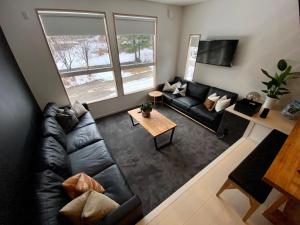 an overhead view of a living room with a black leather couch at ZEN CHALETS Hakuba in Hakuba