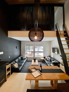 a living room with a couch and a table at ZEN CHALETS Hakuba in Hakuba