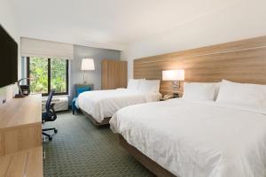 a hotel room with two beds and a desk at Holiday Inn Express San Jose Costa Rica Airport by IHG in Alajuela City