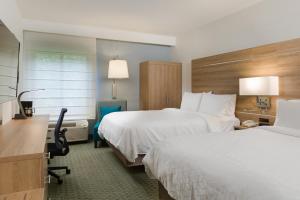 a hotel room with two beds and a desk at Holiday Inn Express San Jose Costa Rica Airport by IHG in Alajuela City