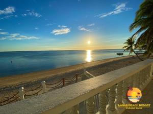 a view of the beach at sunset from a balcony at Lanas Beach Resort in San Jose