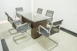 a table and four chairs in a room at Hotel Regency Suites La Feria in Bogotá