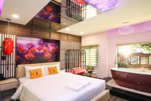 a bedroom with a large bed and a bath tub at EROS Hotel - Love Hotel in Ho Chi Minh City